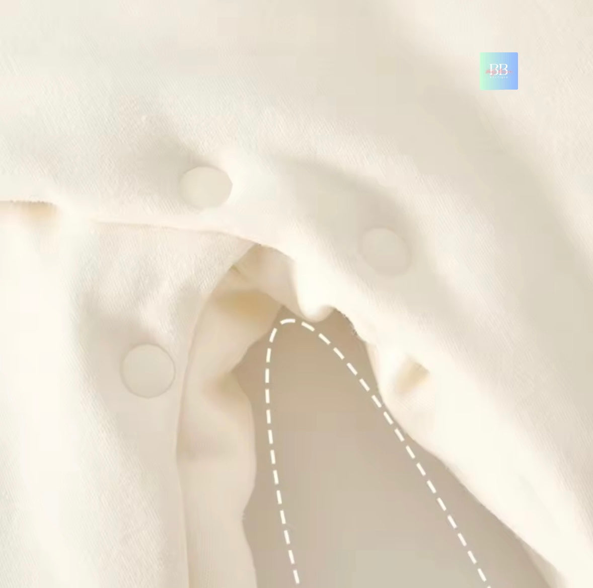 Close-up of a person's neck and shoulders with a white pillow background