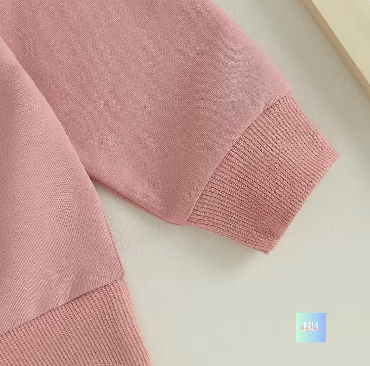 Close-up of a pink sweater on a light background
