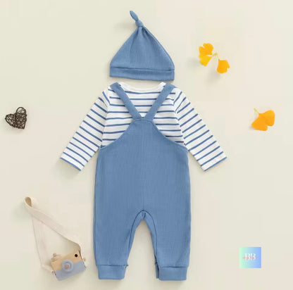 Baby outfit with blue romper, striped shirt, and hat on a light background