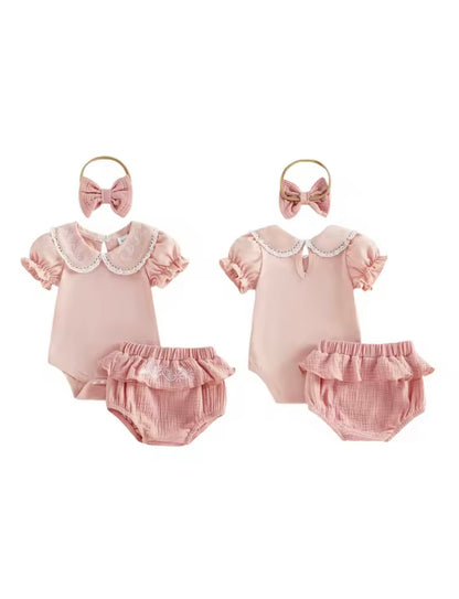 Two baby outfits with pink rompers and bloomers, accompanied by matching headbands on a white background.