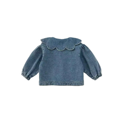 Blue denim jacket with ruffled details on a light gray background
