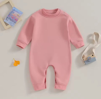 Pink baby onesie on a light gray background
