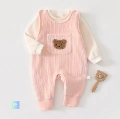 Pink baby romper with bear pocket on a white background
