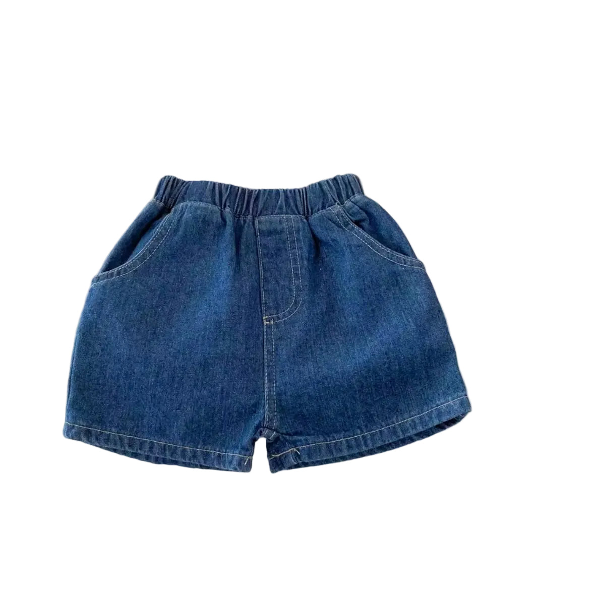 Blue denim shorts on a white surface with a Mickey Mouse coaster and red boots in the background.