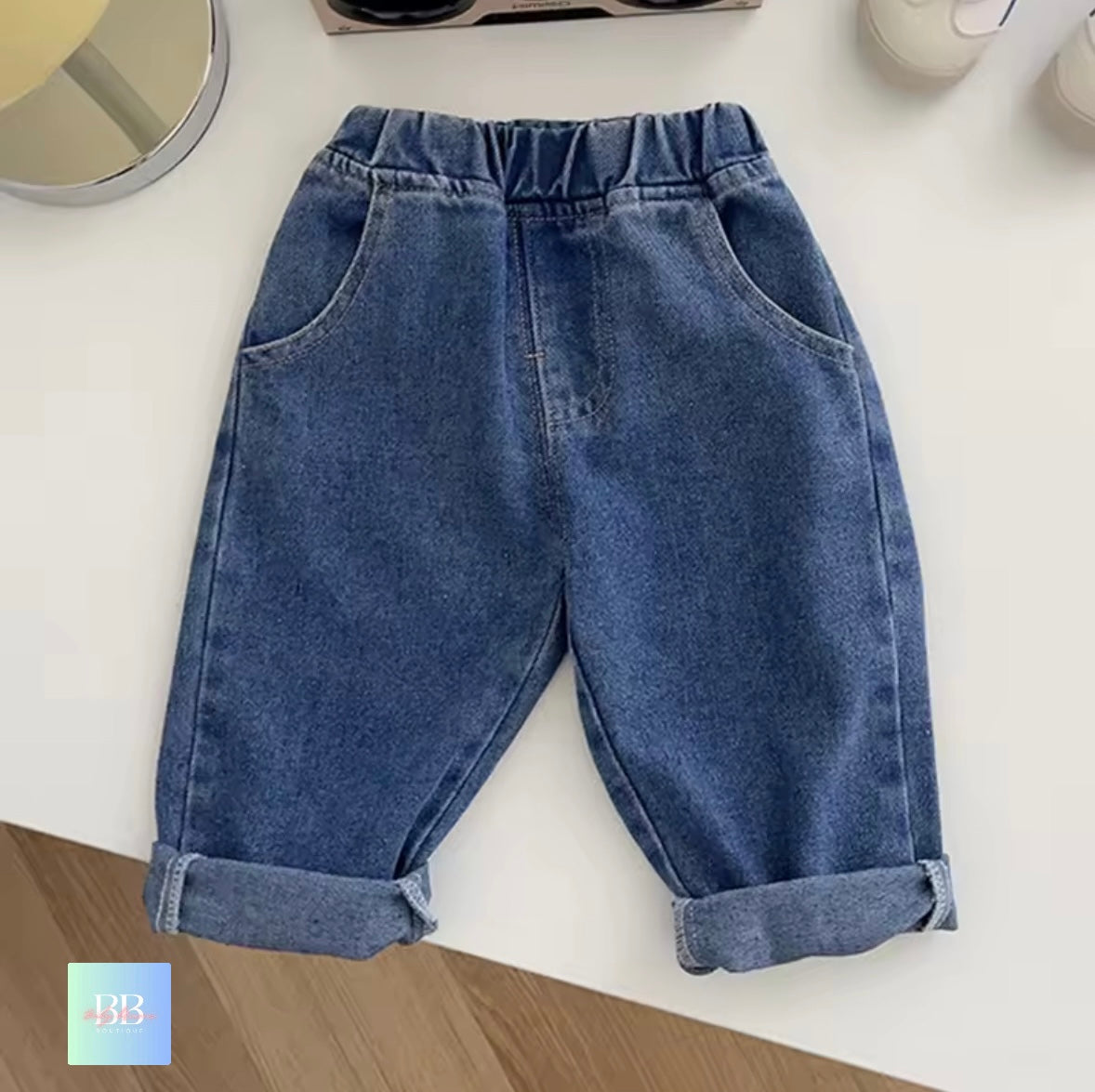 Blue denim pants on a white surface