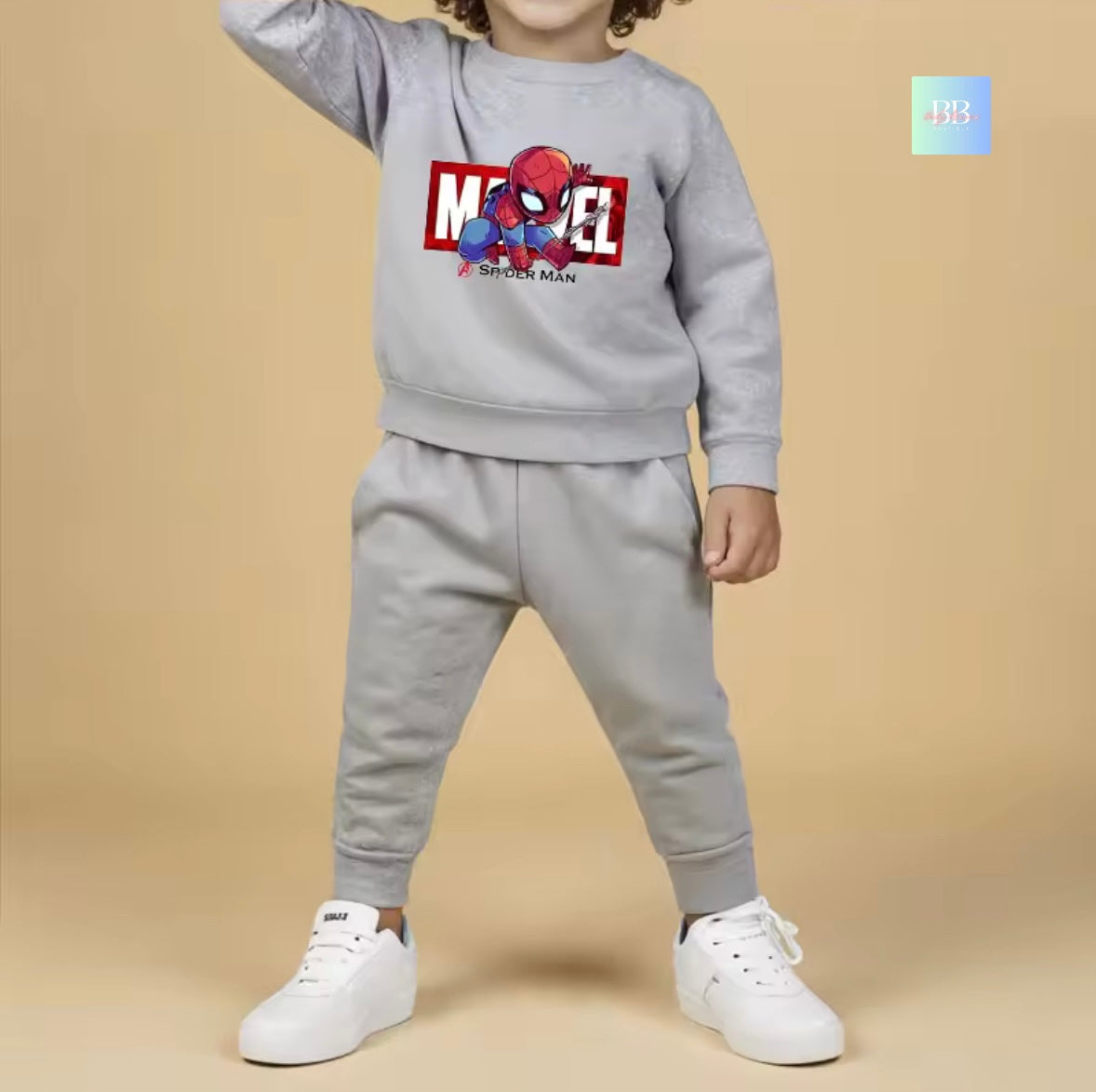 Child wearing a gray Marvel Spider-Man sweatshirt and pants set on a beige background