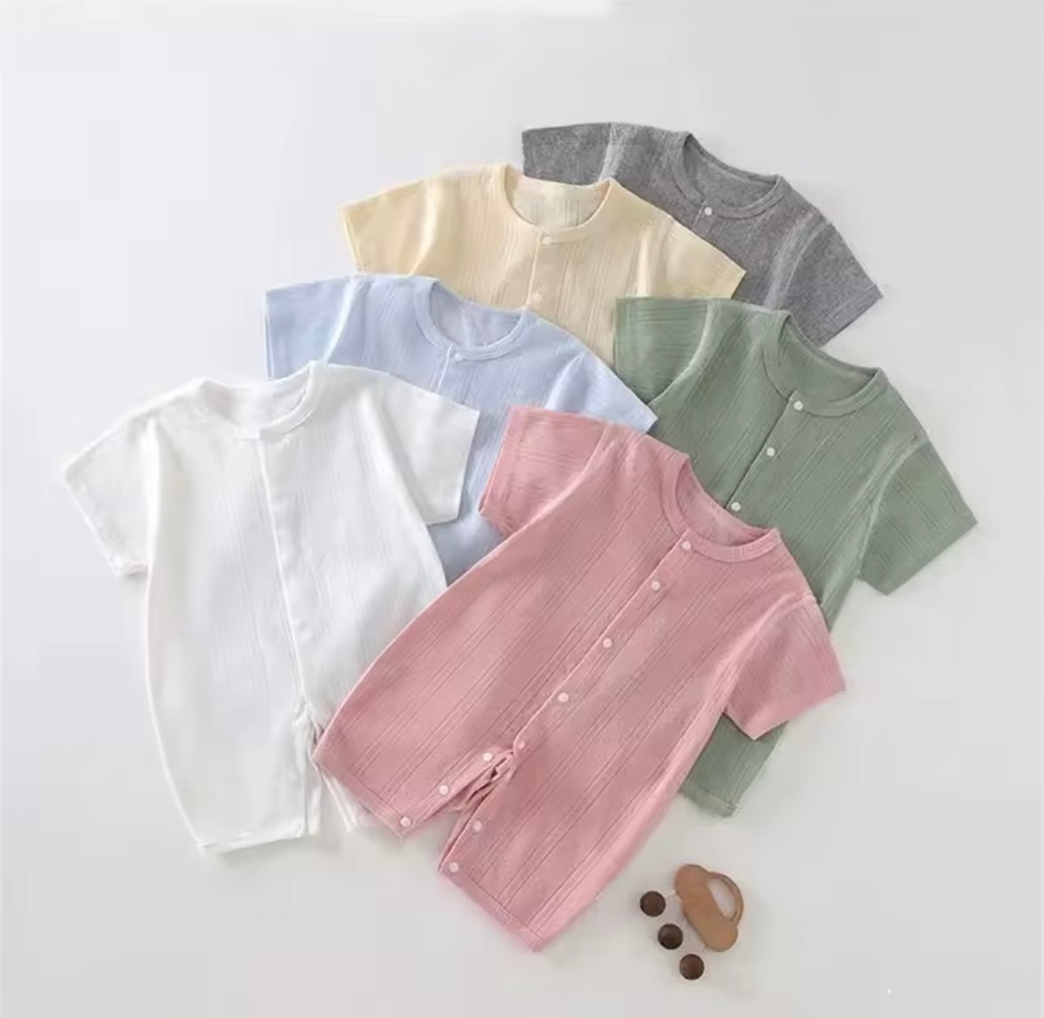 Collection of colorful baby clothes on a white background