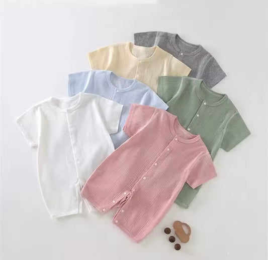 Collection of colorful baby clothes on a white background