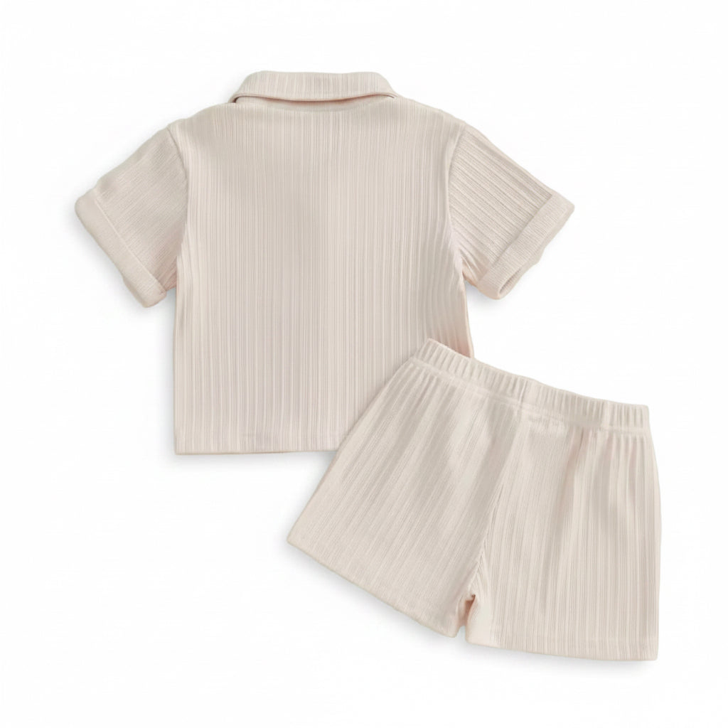 Baby outfit with shirt and shorts on a light background