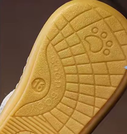 Close-up of a textured yellow sole with brand logo on a dark background
