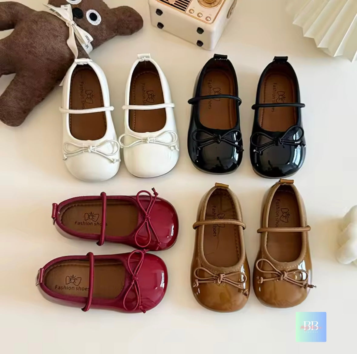 Set of children's shoes in various colors on a light background