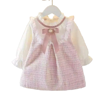 Children's dress with a pink bow on a white background