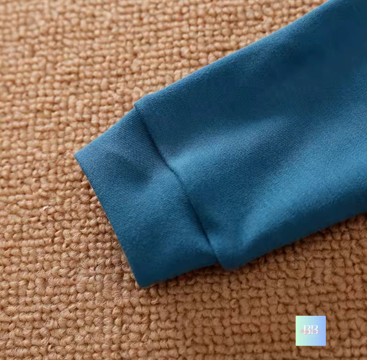 Close-up of a blue fabric edge on a brown textured surface