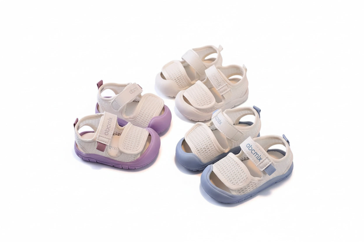 Set of baby sandals on a chair with a neutral background