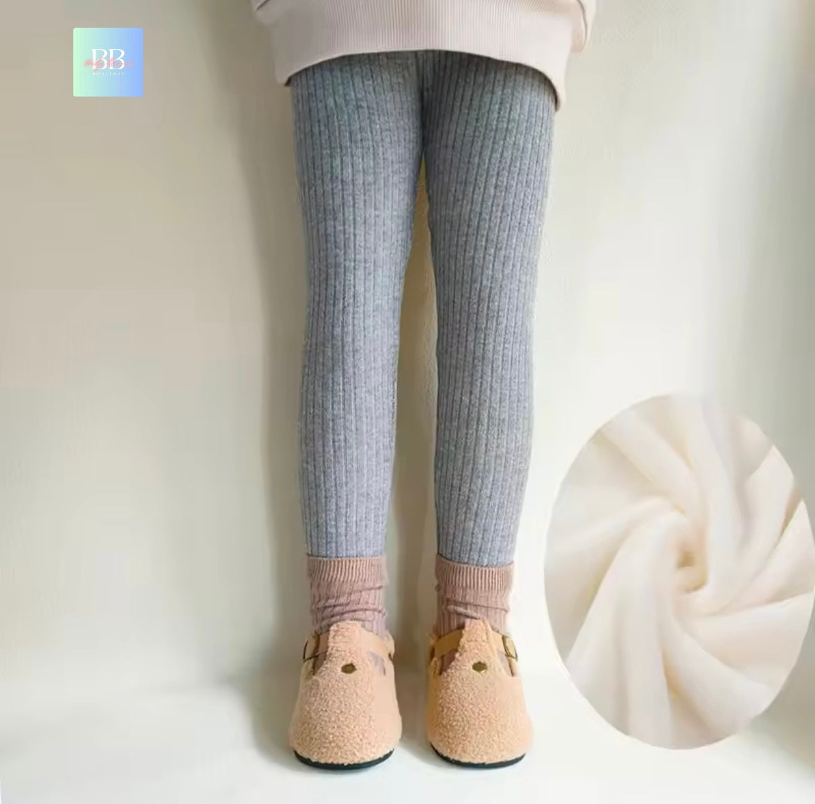 Gray ribbed tights worn by a person on a plain background with a close-up of the fabric texture.
