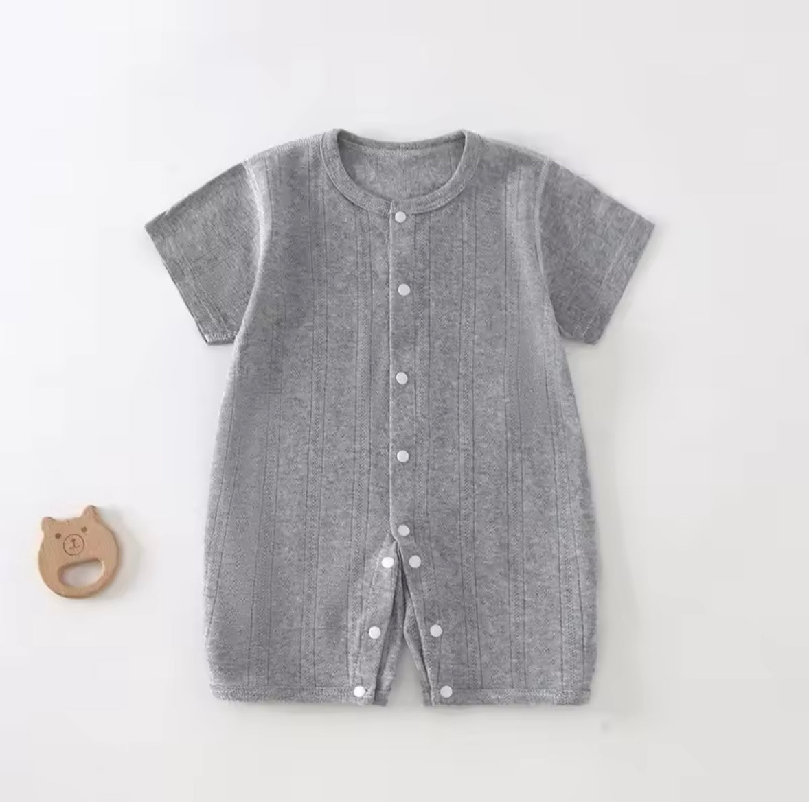 Gray baby romper with buttons on a white background