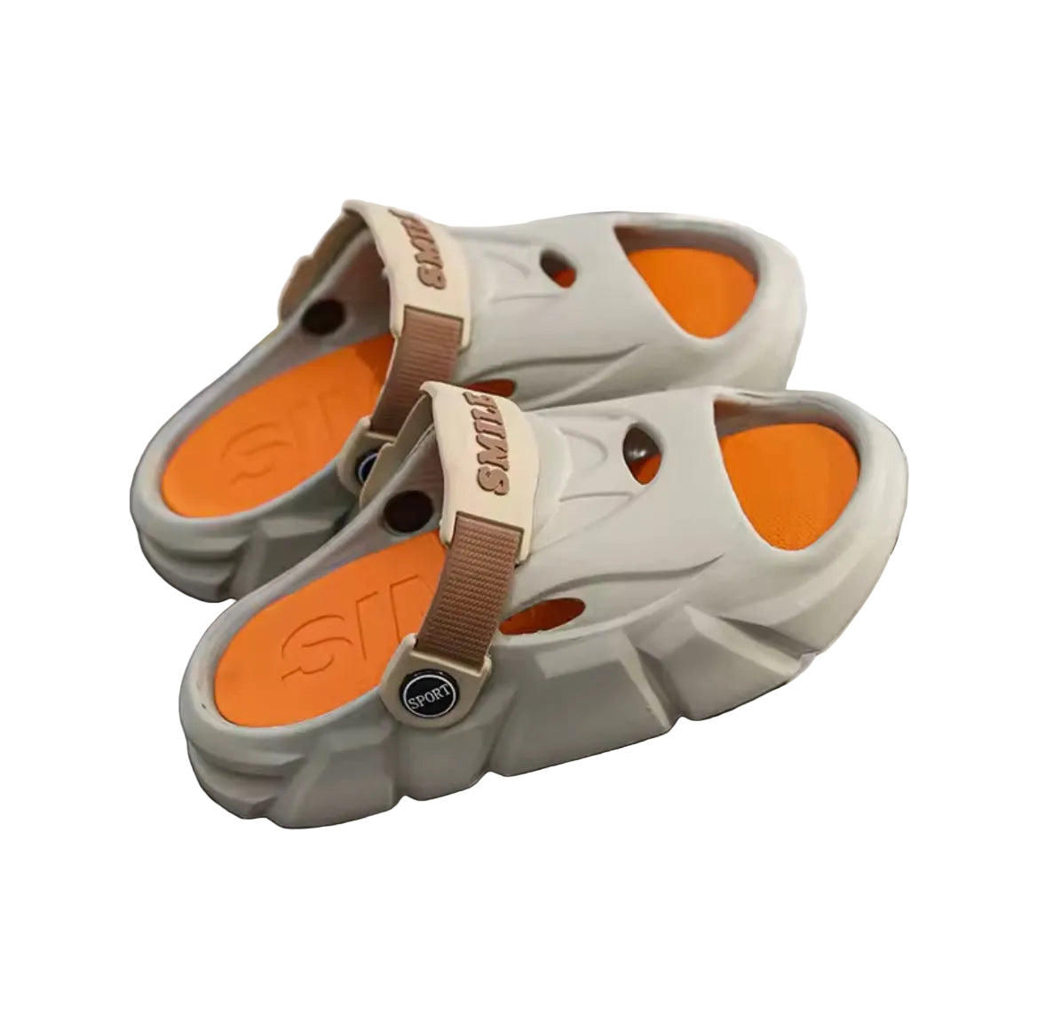Pair of gray sandals with orange soles on a dark surface