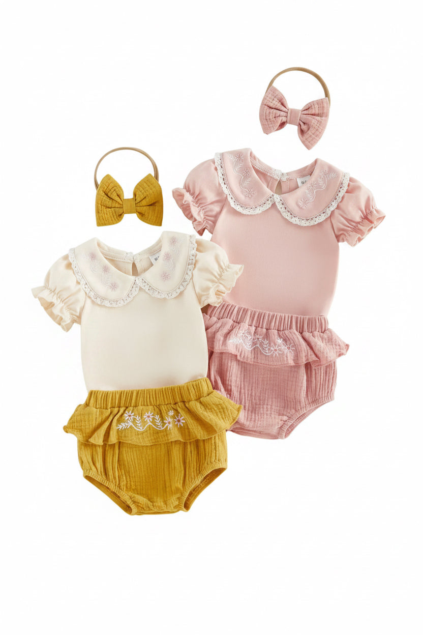 Two baby outfits with ruffled collars and matching headbands on a light background
