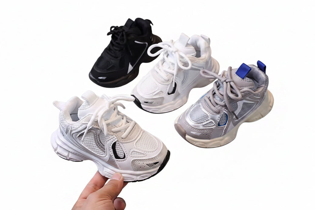 Four pairs of sneakers in black, white, and gray on a white background