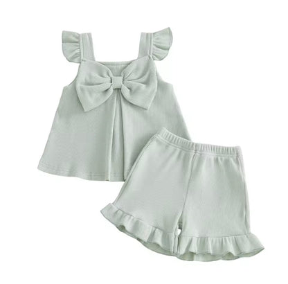 Light green sleeveless top and shorts set with ruffled details on a white background