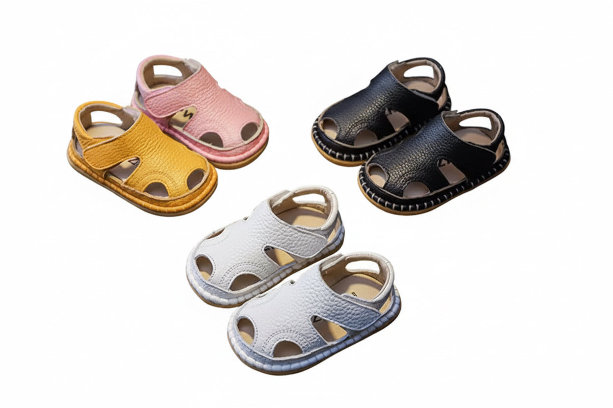 Set of colorful children's sandals on a dark surface