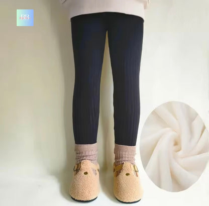 Person wearing navy leggings with a close-up of fabric texture on a white background