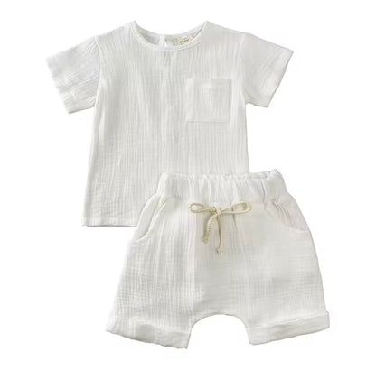 White baby romper with short sleeves and drawstring shorts on a white background