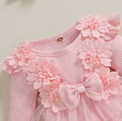 Pink dress with floral embellishments on a light background