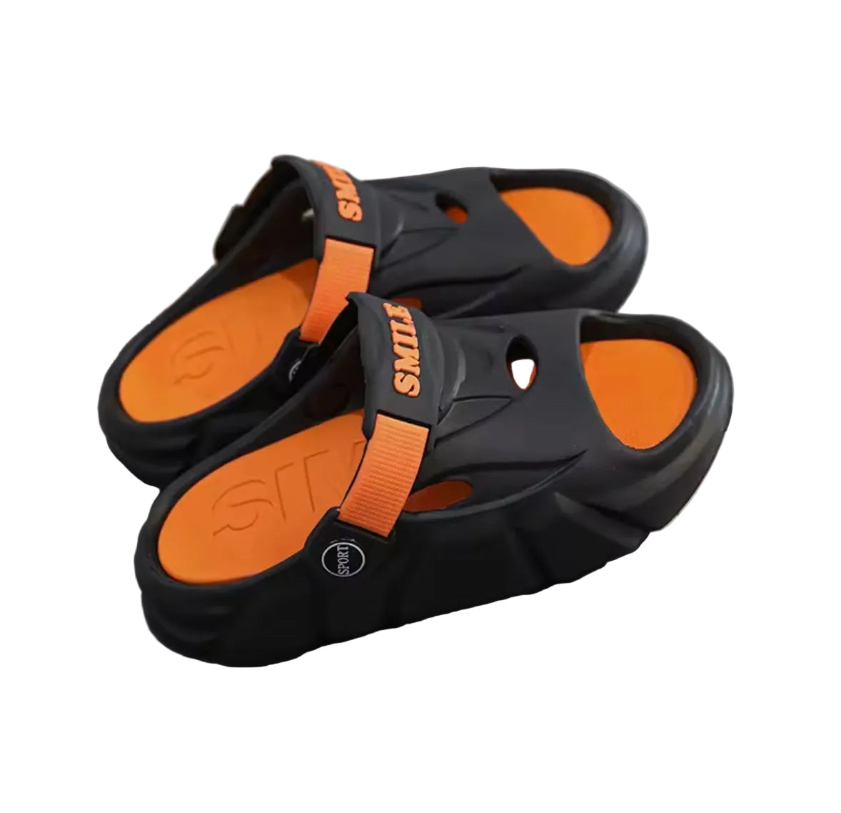 Black and orange sandals on a reflective surface with a blurred background