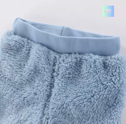 Close-up of a fluffy blue blanket with a plain background