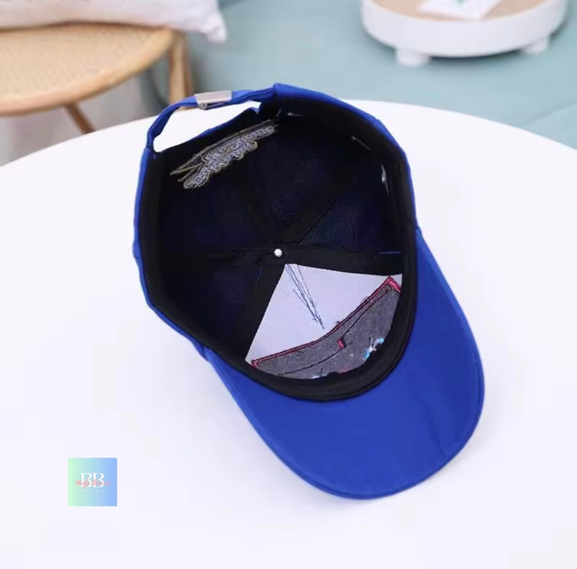 Blue cap with a reflective interior on a white surface