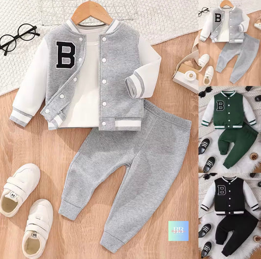 Children's gray varsity jacket and pants set with white shirt and shoes on a wooden surface.