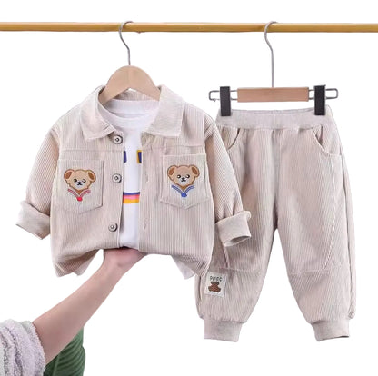 Children's clothing set with jacket and pants on hangers against a neutral background