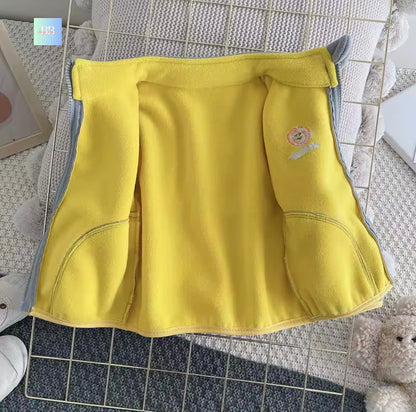 Yellow children's shorts with a cartoon character on a textured surface