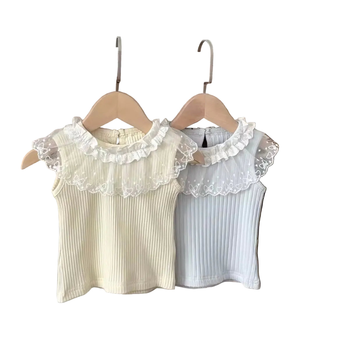 Two sleeveless tops with lace collars hanging on wooden hangers against a neutral background.