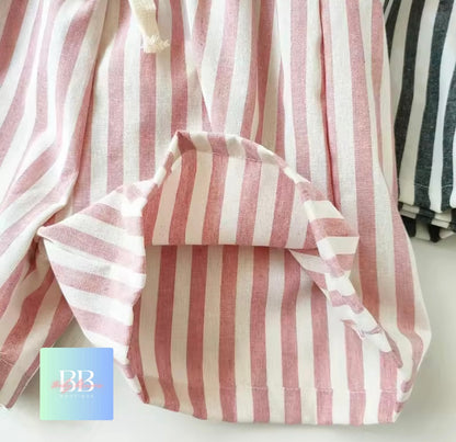Pink and white striped fabric with a drawstring on a light background