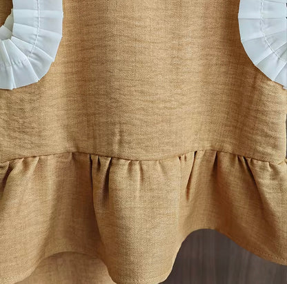 Brown dress with white petal details on a neutral background