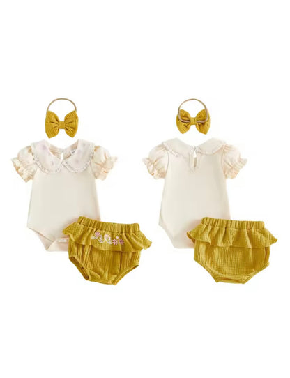 Two baby outfits with white tops and mustard yellow bloomers, accompanied by matching headbands on a white background.