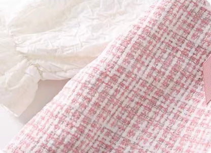 Close-up of a pink and white checkered fabric with a soft texture.