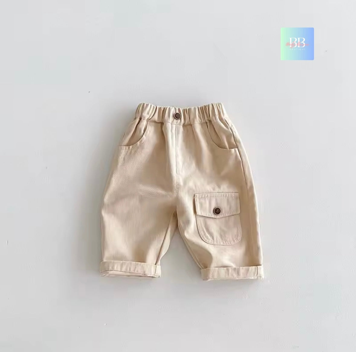 Beige shorts with a pocket on a light gray background