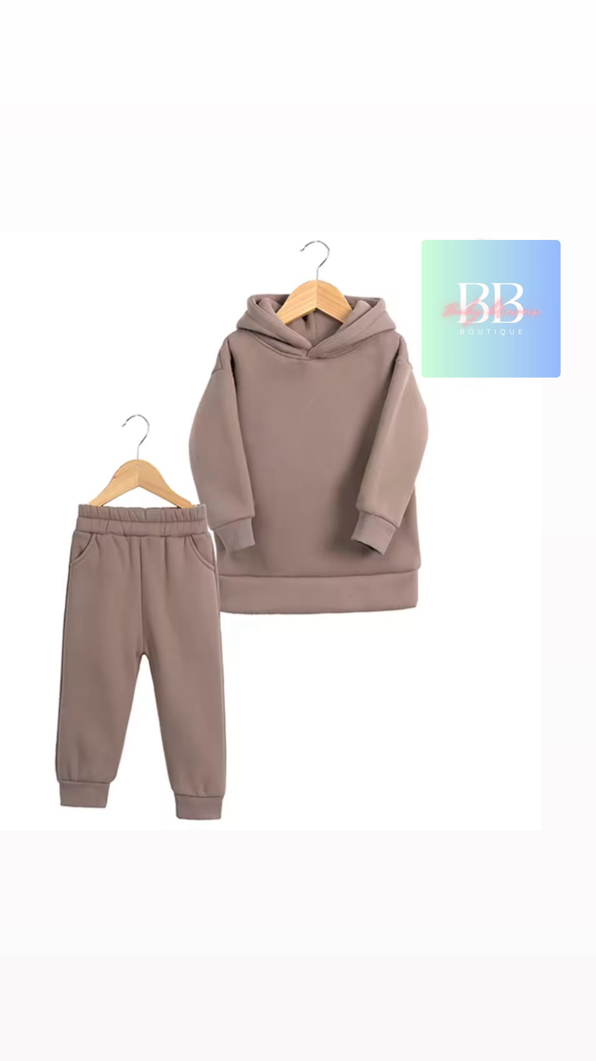 Brown hoodie and pants set on hangers with a visible brand logo on a white background