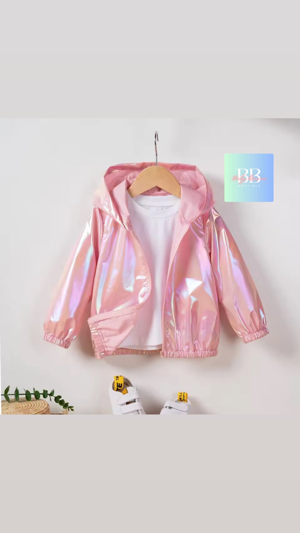Pink reflective jacket on a hanger against a white background