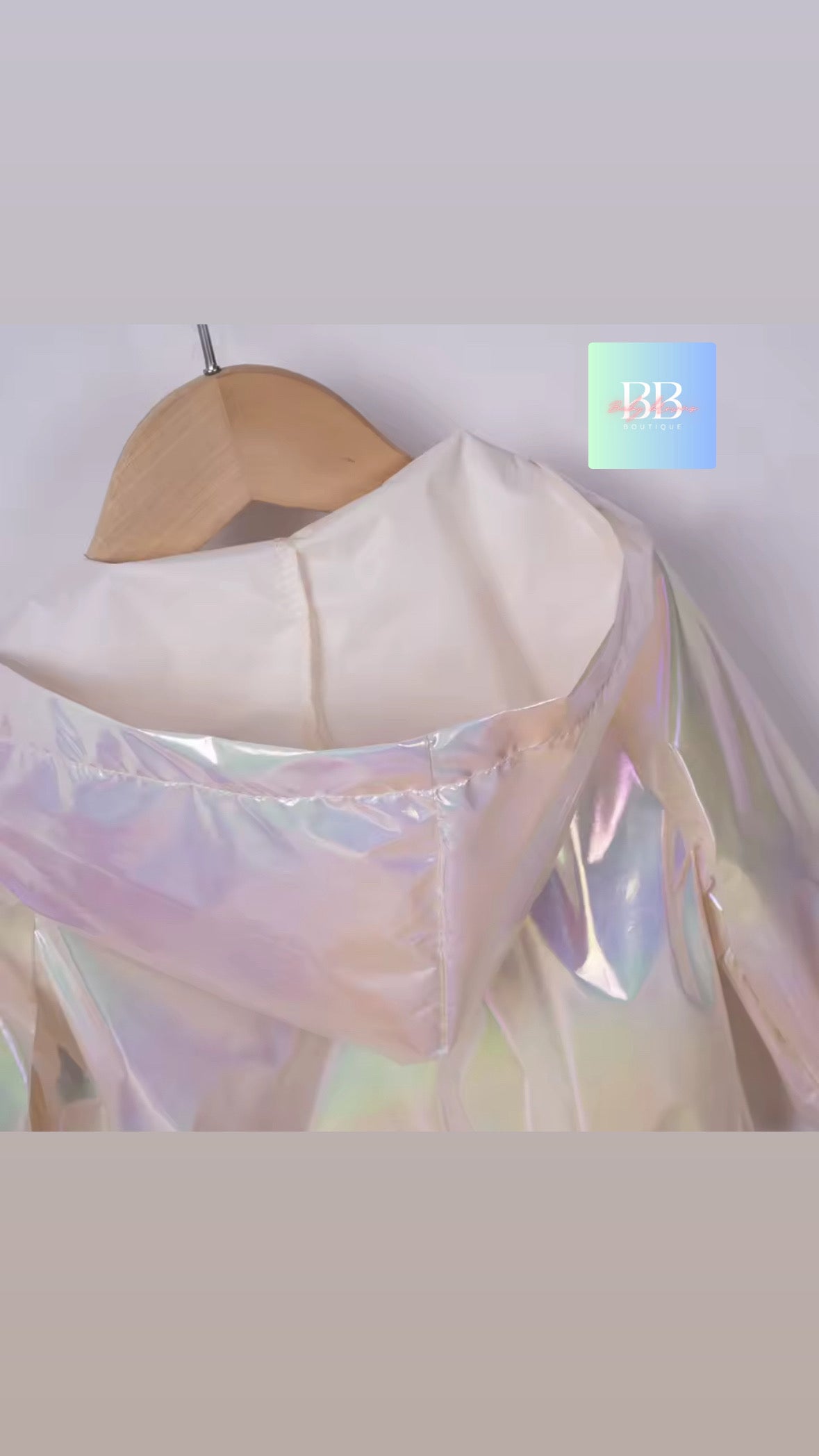 Holographic fabric on a wooden hanger against a light background