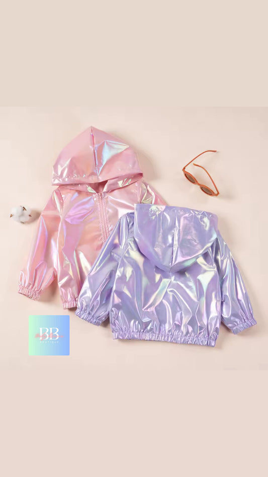 Two iridescent hoodies, one pink and one purple, on a beige background.