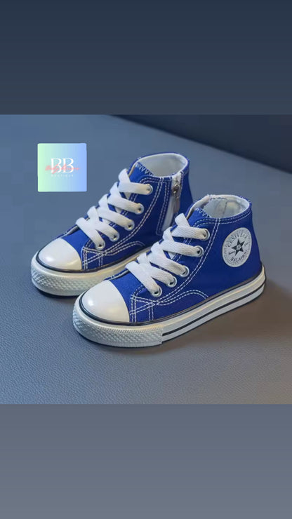 Pair of blue high-top sneakers with white laces on a gray background