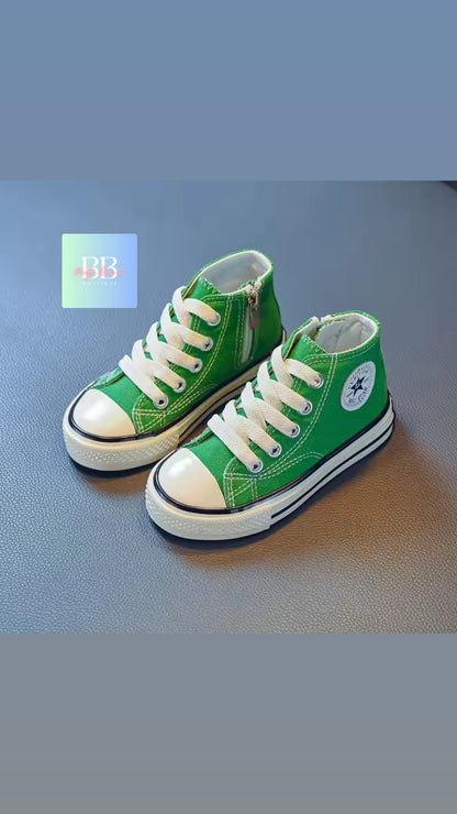 Green high-top sneakers with white laces on a blue surface