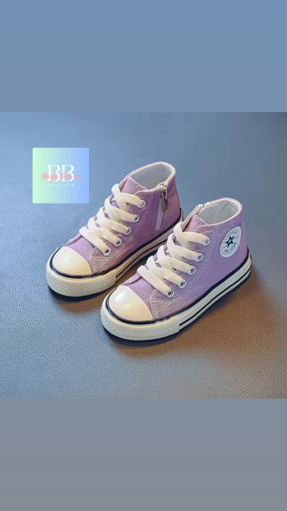 Pair of purple high-top sneakers on a blue background