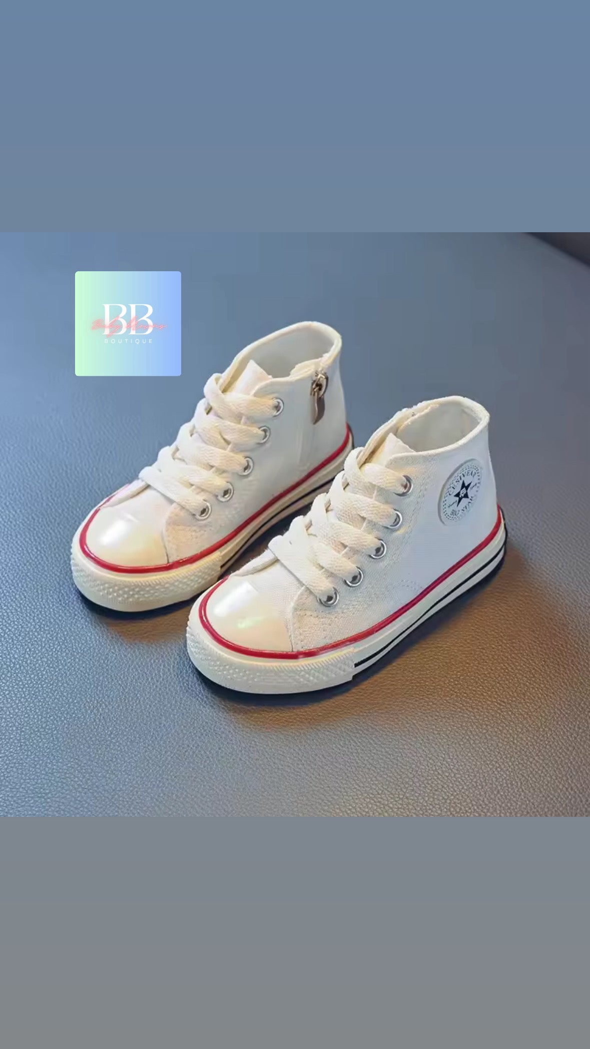 White high-top sneakers with red accents on a blue surface