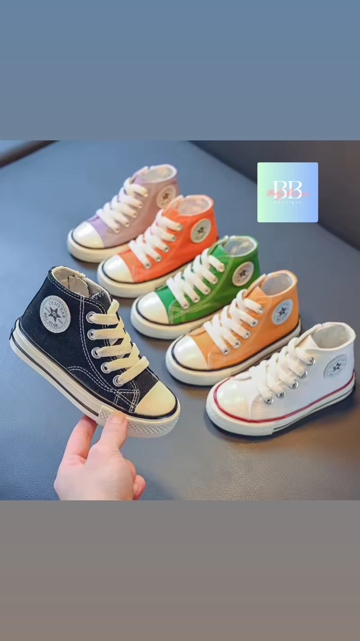 Colorful children's high-top sneakers on a blue surface