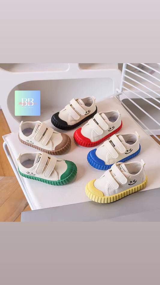 Colorful children's shoes on a white surface with a blurred background